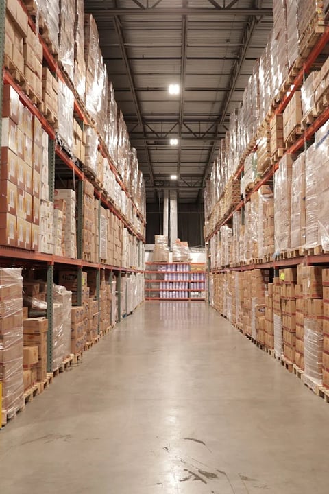 Aisle of a food distributor's warehouse stocked and staged for nationwide wholesale shipping
